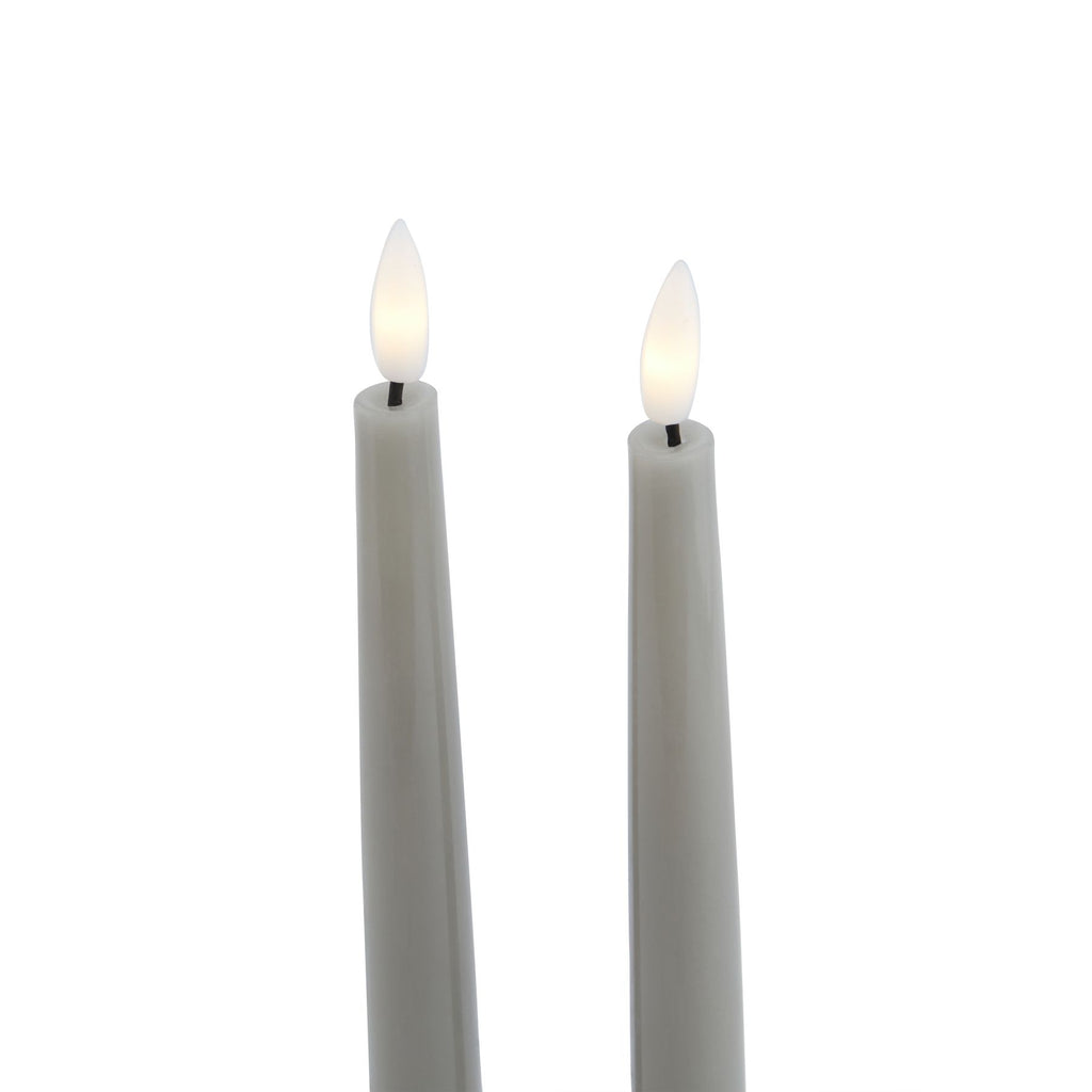 Close-up of the grey candle tops, showing white flame-shaped inserts with pale yellow centres on short dark stems.