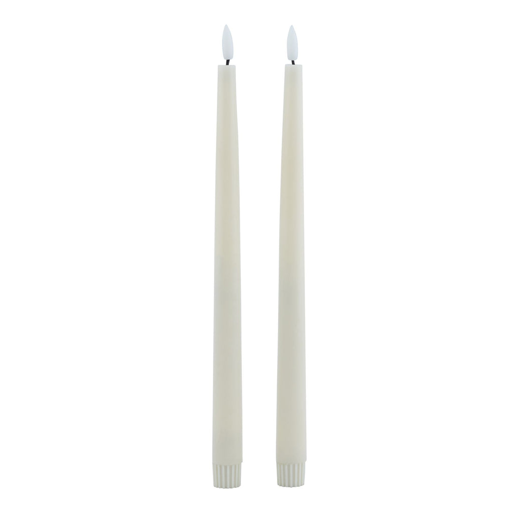 Two slim pale LED dinner candles against a white background, with plain white flame-shaped inserts and ribbed lower caps.