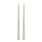 Two slim pale LED dinner candles against a white background, with plain white flame-shaped inserts and ribbed lower caps.