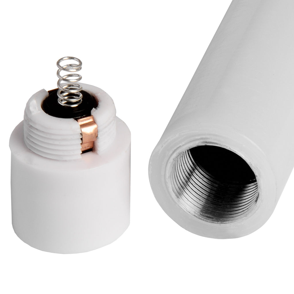 Close-up of a white candle's detached threaded lower cap with a silver-toned spring and copper-coloured strip beside the open threaded candle body.