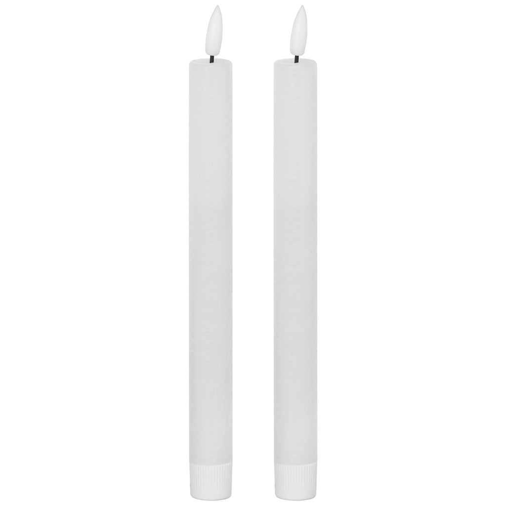 Two matching unlit white LED dinner candles with slender bodies, fluted lower sleeves and white flame-shaped tips on dark stems.