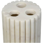 Close-up of the holder's white marble top, three circular slots and rounded vertical ribs.