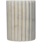 Side view of the cylindrical toothbrush holder showing pale marble veining across the fluted surface.