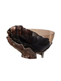 Three-quarter view of a smoked glass bowl held within a bronze-toned folded metal surround on a white background.