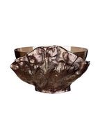 Rear view showing the broad, textured bronze-toned surround with an irregular upper edge and the glass bowl behind it.