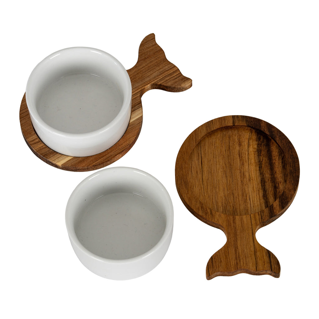 One white bowl seated on a fish-shaped tray beside a separate bowl and an empty brown tray showing its circular recess.