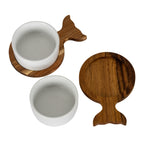 One white bowl seated on a fish-shaped tray beside a separate bowl and an empty brown tray showing its circular recess.