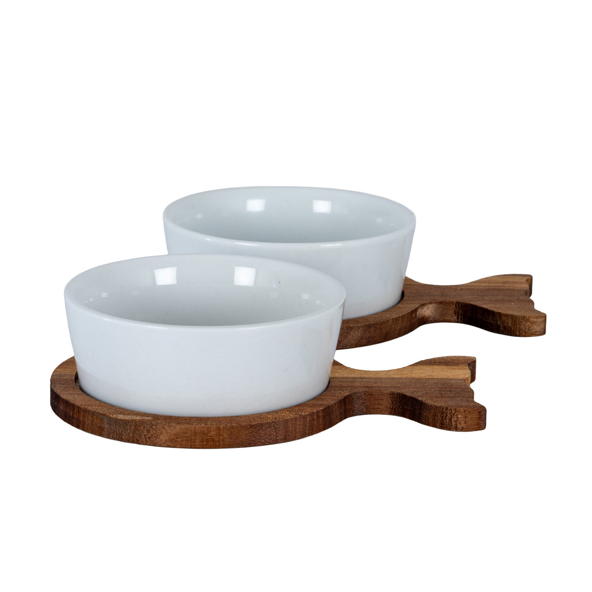 Two glossy white bowls on brown fish-shaped trays, viewed from a low angle with both forked tails pointing right.
