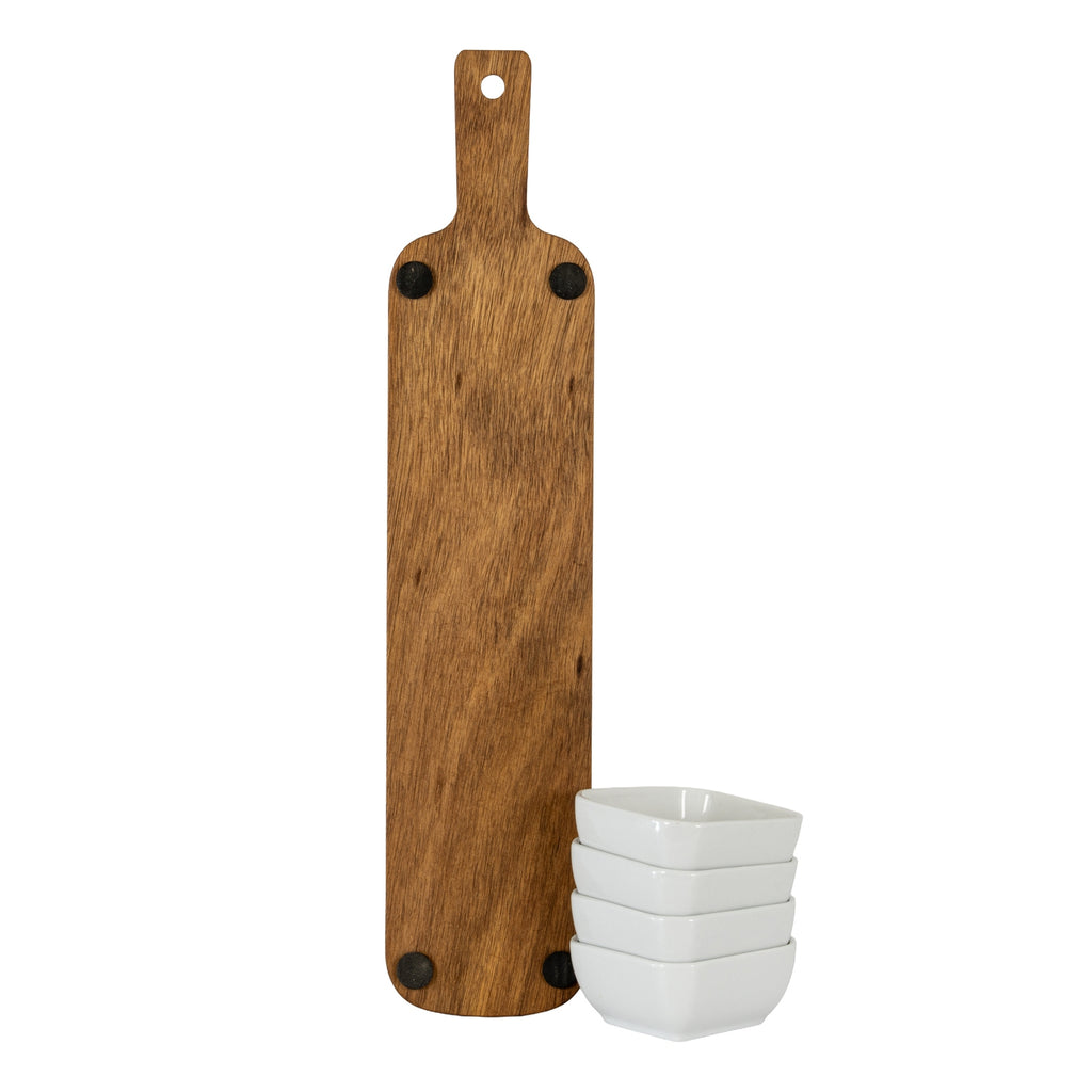 Underside of the upright paddle-shaped board showing four dark round pads, with four white bowls stacked beside its lower edge.