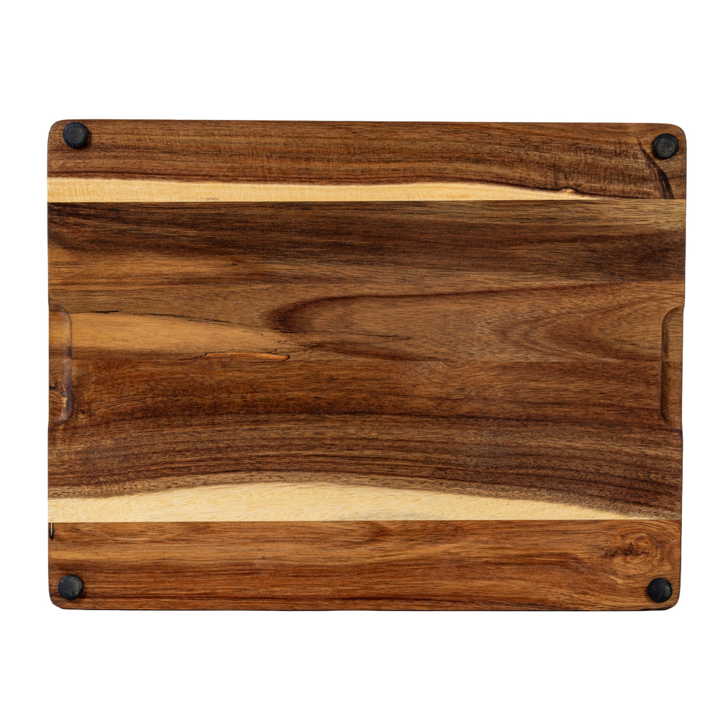 Underside of the rectangular brown grained board, with four black round pads near the corners.