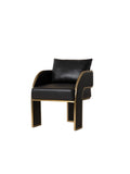 Three-quarter front view of a black dining armchair with a separate back cushion, curved arms, channel-stitched side panels and broad legs edged in gold.