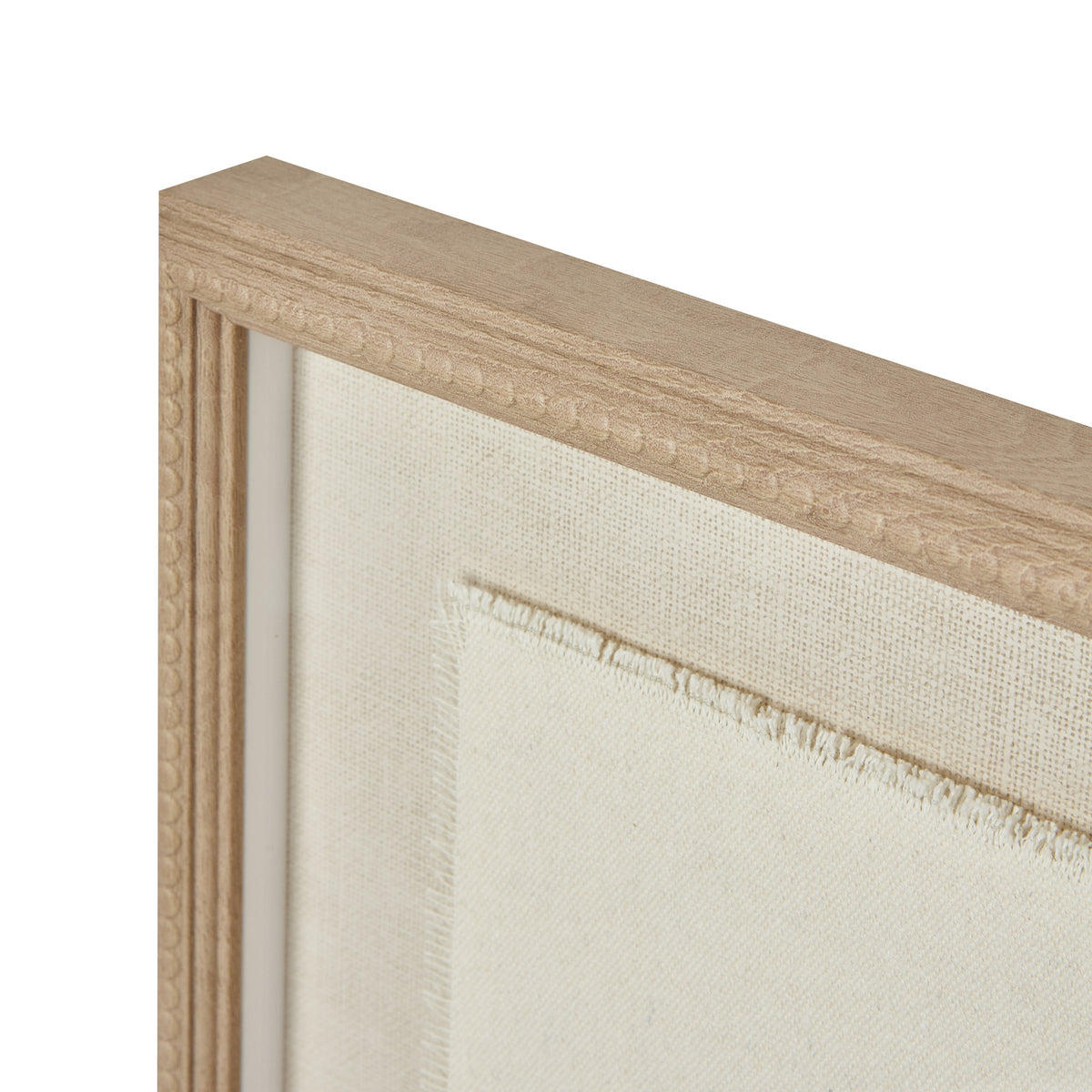 Angled detail of the upper frame corner, showing the tan beaded border and the frayed edge of the pale inner panel.