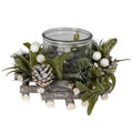 Frosted Berry Candle Wreath with green leaf shapes, white berries, pale-tipped cones and brown branch-like details surrounding a clear central vessel against a white background.