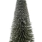 Close-up of the tree's dark radial bristles, showing irregular white flocking along the upper surfaces and tips of the layered tiers.