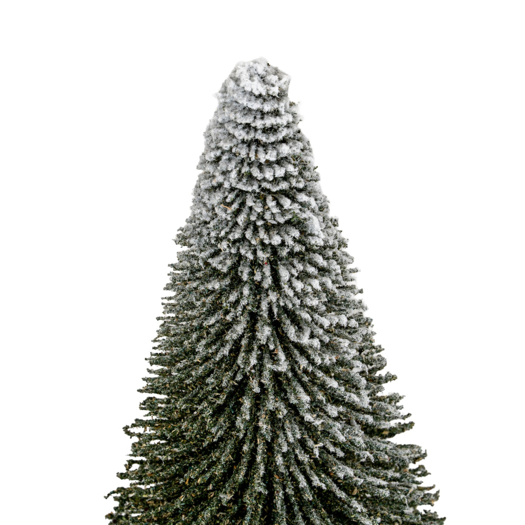 Close-up of the decorative tree's dense radiating bristle branches, showing the heavy white frosted coating around the tip.