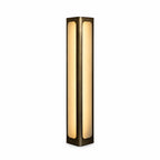 Illuminated floor uplighter with a dark smoke-gold column frame and two visible long frosted panels, shown against white.