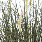 Close-up of pale fuzzy seed heads among crossing narrow green blades in the artificial grass arrangement.