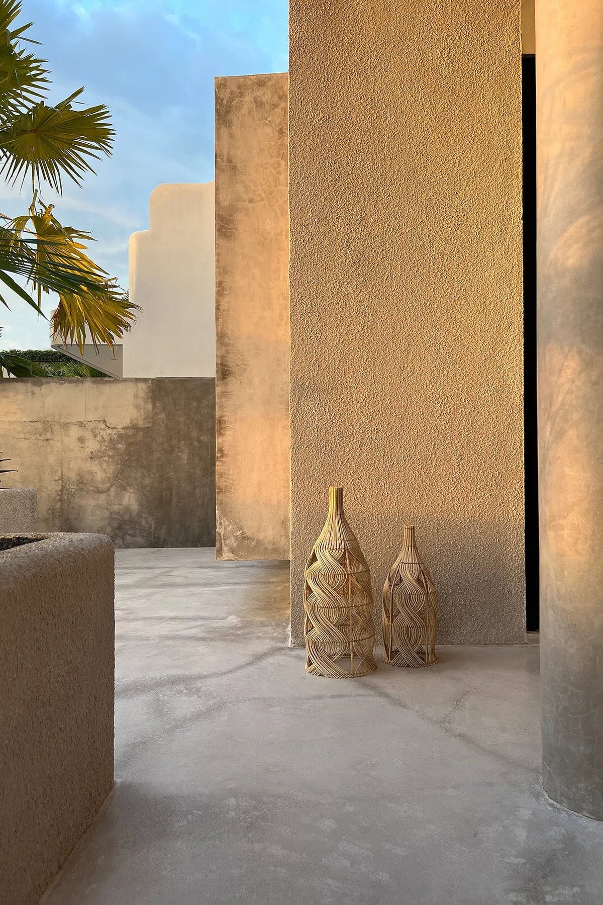 Garaffa Rattan Pendant Light – Natural, Large – large and small pendants styled in an outdoor corridor