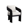 Three-quarter view of a black woven dining chair with curved arms, broad woven legs and cream textured seat and back cushions on a white background.