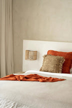 Gigi Rattan Wall Applique – Natural, Small – styled above a bed