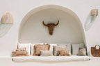 Gigi Rattan Wall Applique – Natural, Small – paired wall lights beside an arched seating alcove