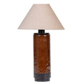 Front view of a glossy coffee-brown cylindrical table lamp with dark metal detailing and a wide, natural-toned tapered fabric shade on a white background.