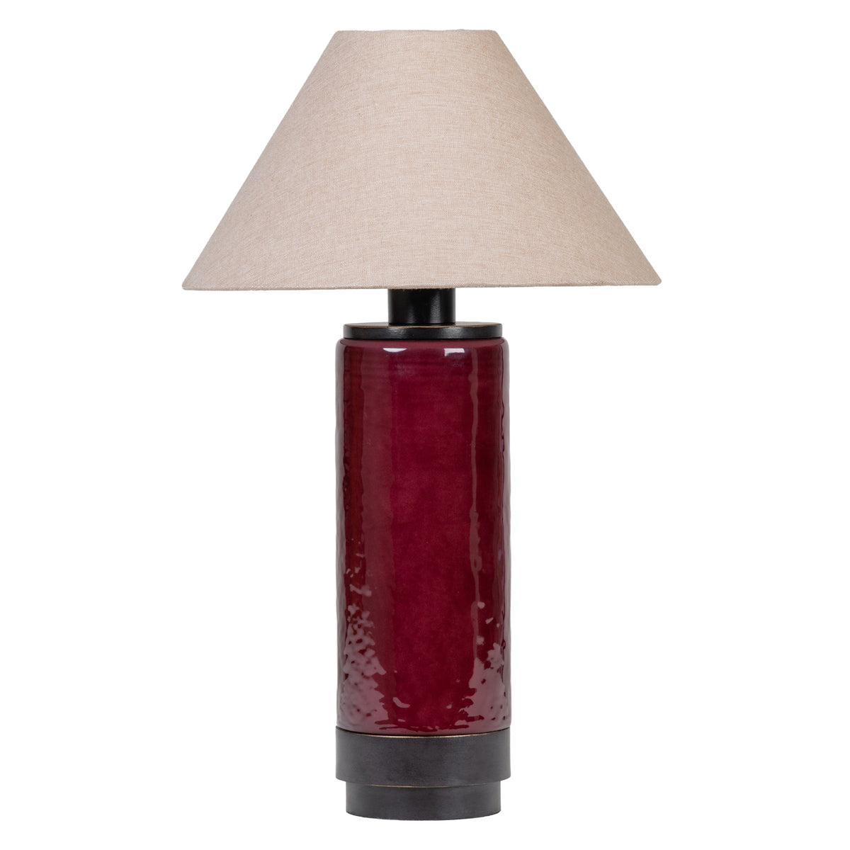 Front view of a table lamp with a glossy deep red cylindrical body, dark top and base bands, and a broad tapered natural-toned fabric shade on white.