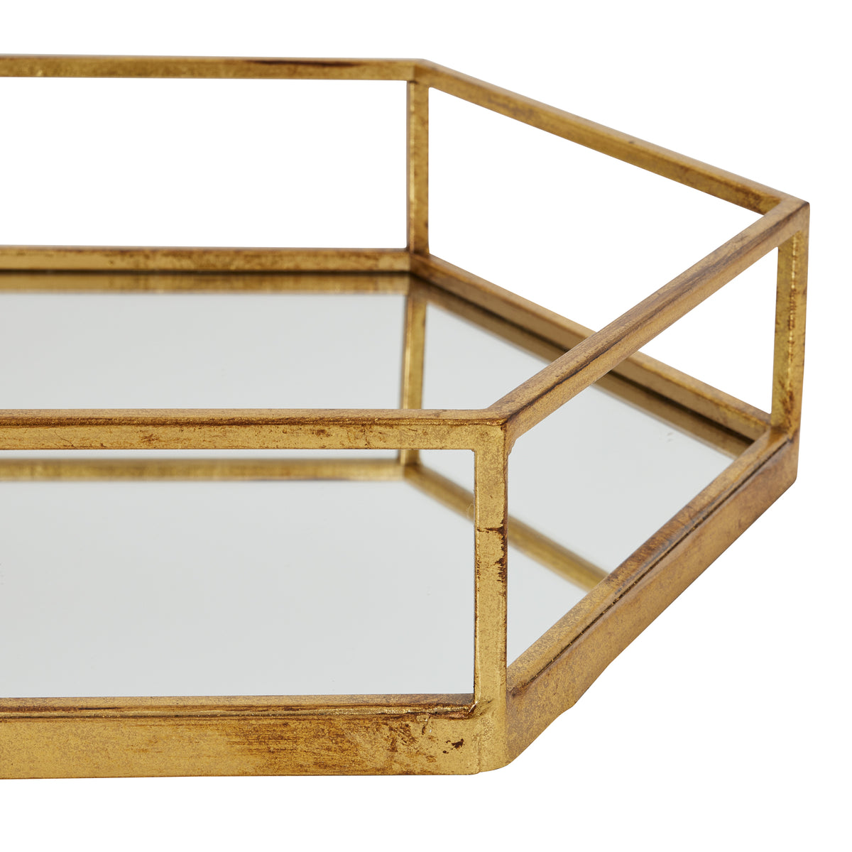 Close-up of the tray's front and right-hand corner, with gold-toned geometric rails above reflective side panels.