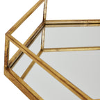 Close-up looking into a hexagonal tray corner, showing the reflective base and side panels beneath the open gold-toned rail.