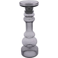 Large smoky grey glass candle holder viewed from the front, with a rounded shaped stem and circular platform.