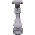 Large smoky grey glass candle holder viewed from the front, with a rounded shaped stem and circular platform.