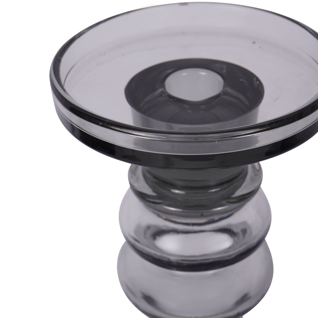 Angled close-up of the glass candle platform, showing its raised rim, central recess and rounded upper stem.