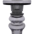Front close-up of the candle holder's smoky grey platform and collar above two rounded glass sections.