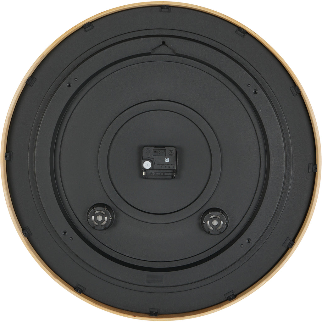Rear view of the clock showing a black circular back, central battery compartment and hanging slot near the top.