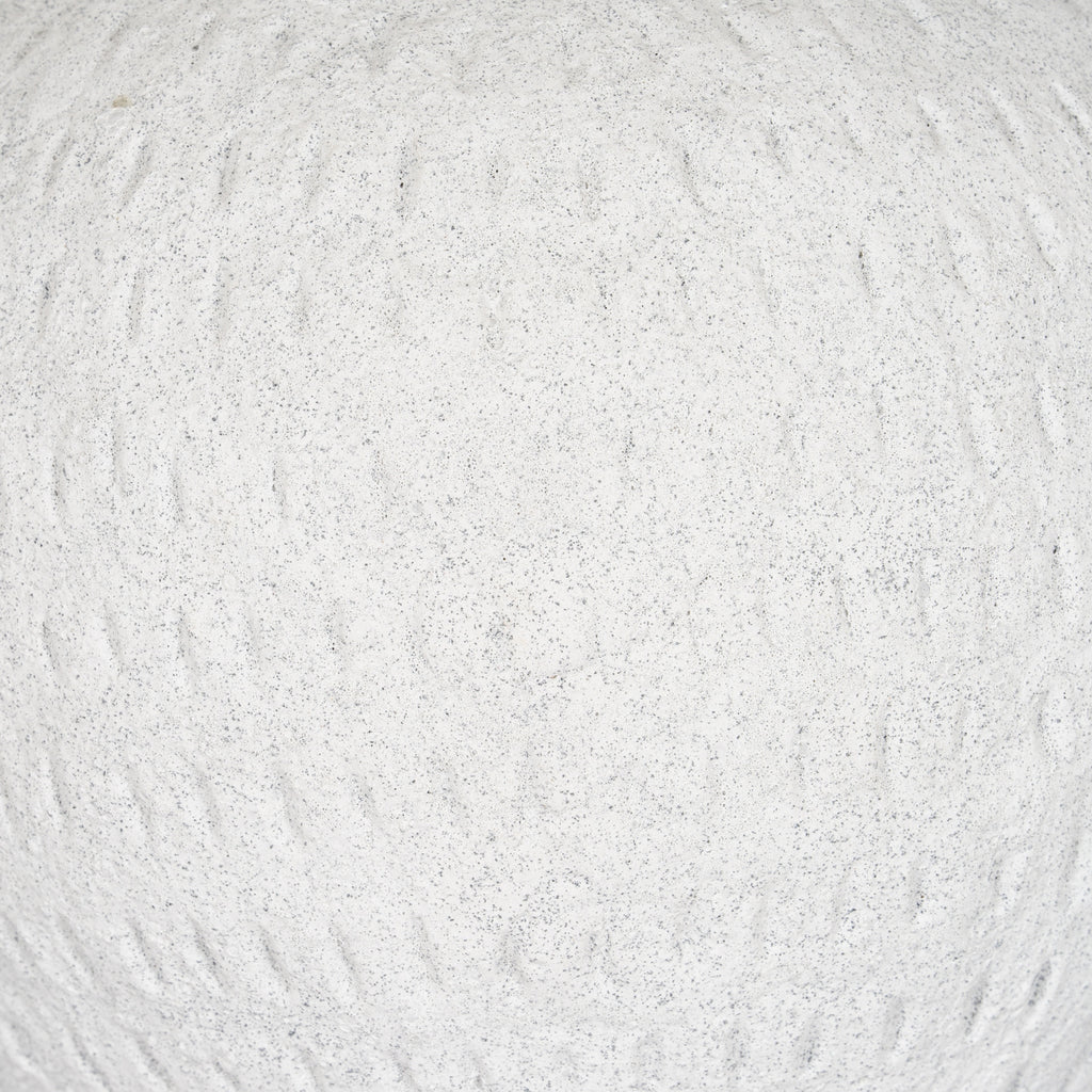 Detail of the vase's granular off-white exterior, with fine grey speckles and shallow uneven vertical markings.