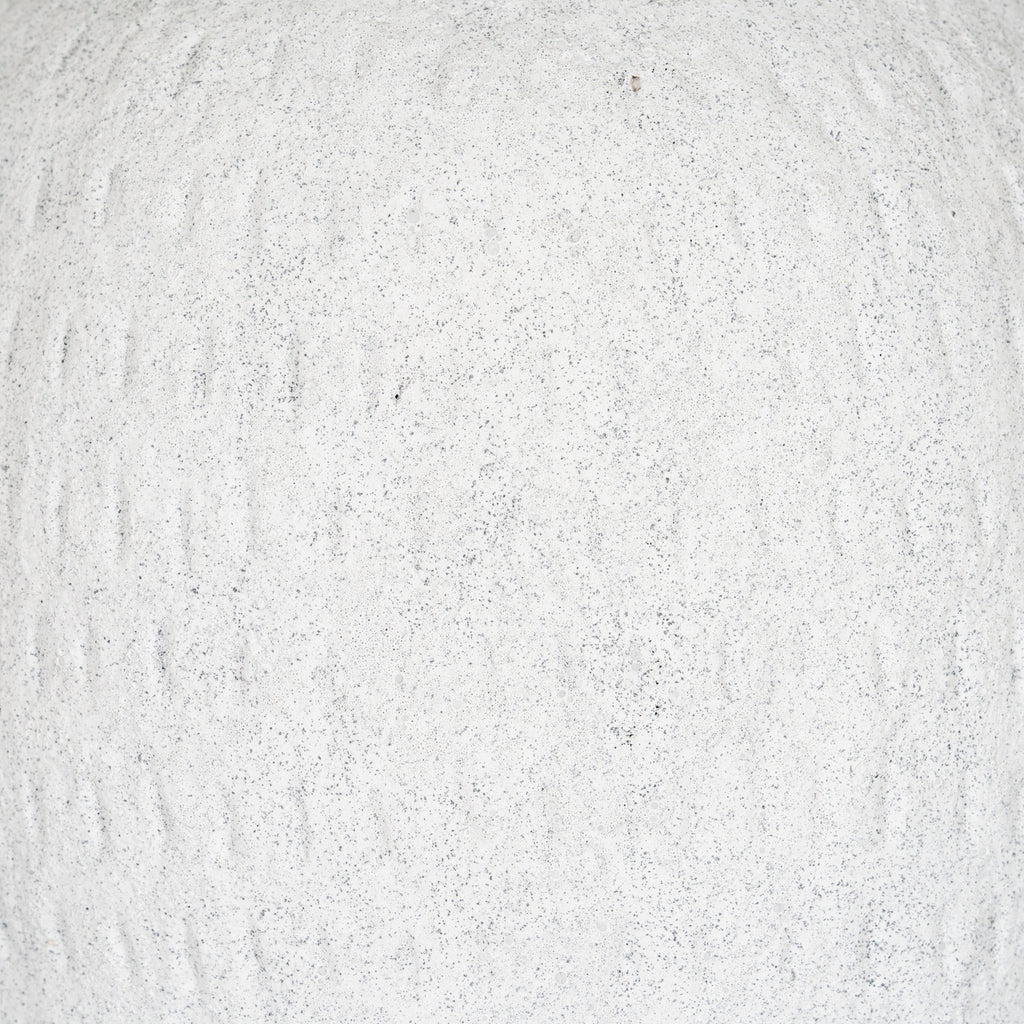 Detail of the vase's granular off-white surface with fine grey speckles and irregular shallow vertical strokes.