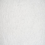 Close-up of the off-white granular surface, with fine grey flecks and irregular shallow vertical grooves.