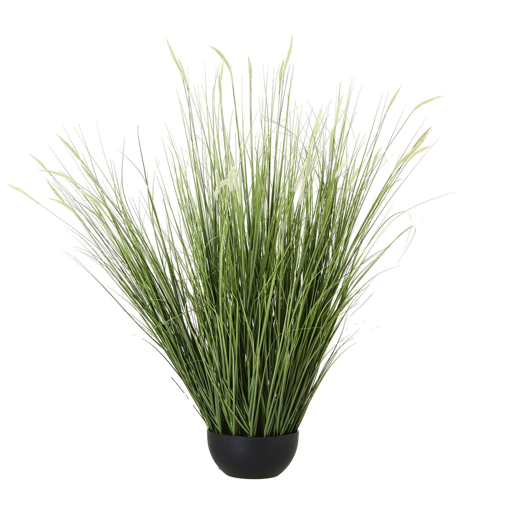 Artificial grass plant with dense green blades fanning out around pale seed heads above a low rounded black pot.