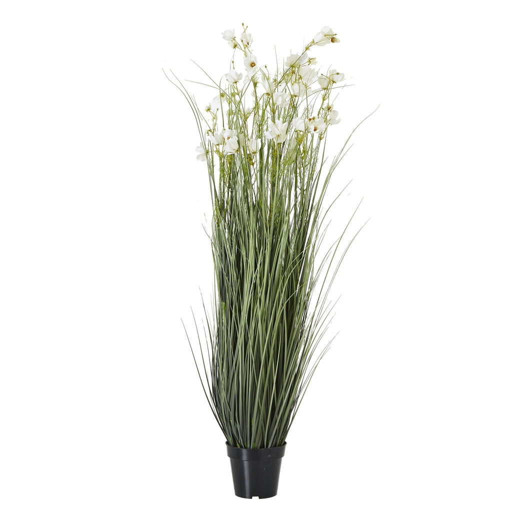 Full view of a tall artificial arrangement with upright grey-green grass and scattered white flowers in a black tapered pot.
