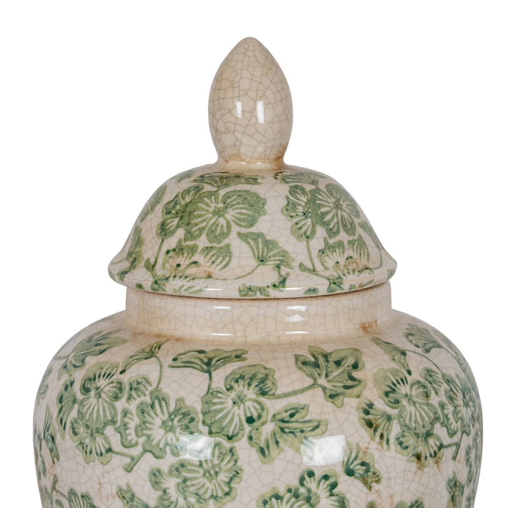 Close-up of the ginger jar's pointed-oval finial, domed floral lid and shoulder, showing fine crackle lines and tan ageing marks.