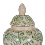 Close-up of the ginger jar's pointed-oval finial, domed floral lid and shoulder, showing fine crackle lines and tan ageing marks.