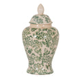 Cream ginger jar covered in green flowers and leaves, with a crackle-effect surface, domed lid and tall cream knob, shown against white.