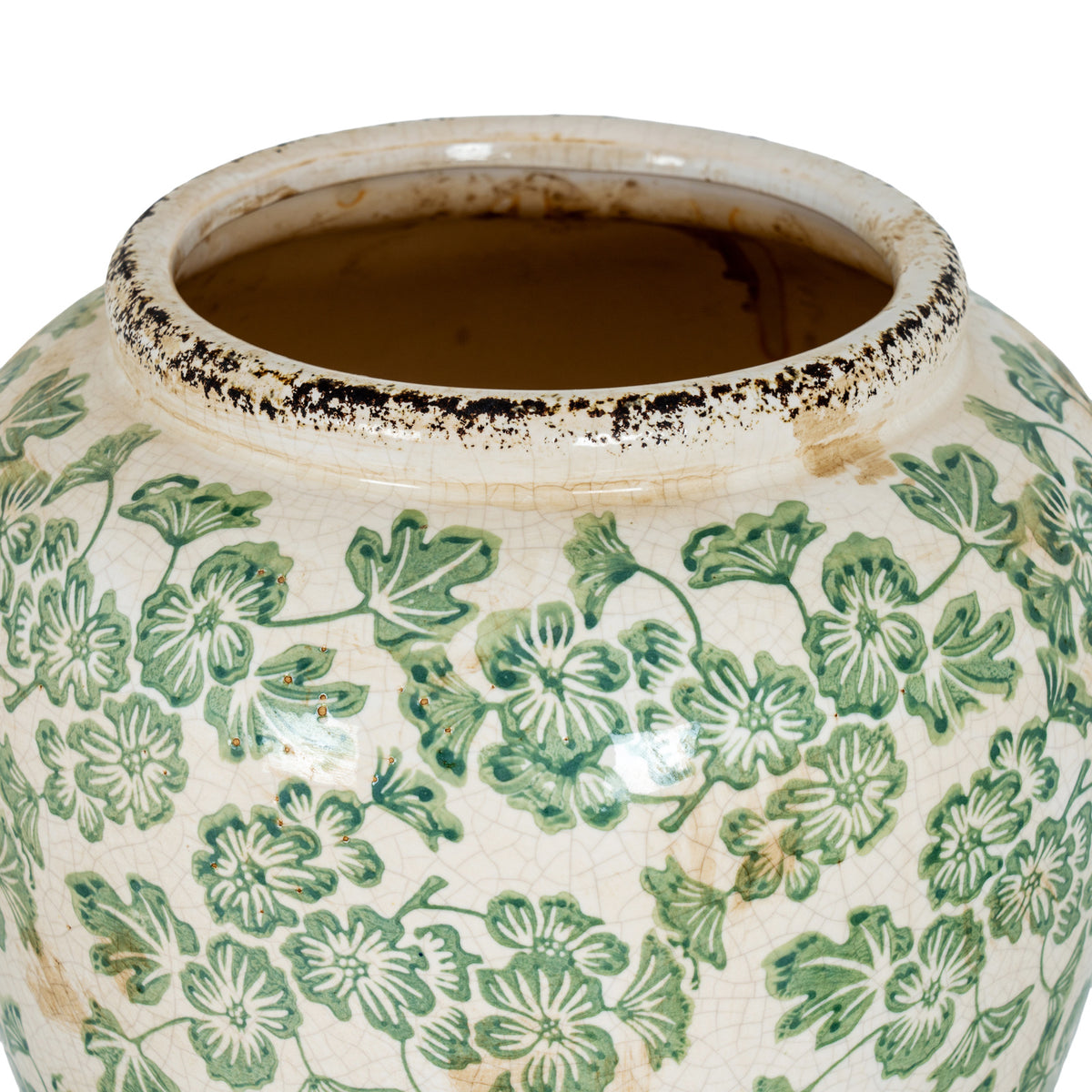 View into the vase opening, with a raised cream-white rim edged in dark distressed marks above the green floral pattern.