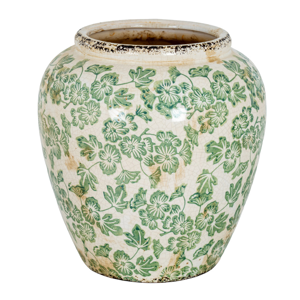 Rounded cream-white vase with green flowers and leaves, gently tapering sides and dark distressed detailing at the rim and base.