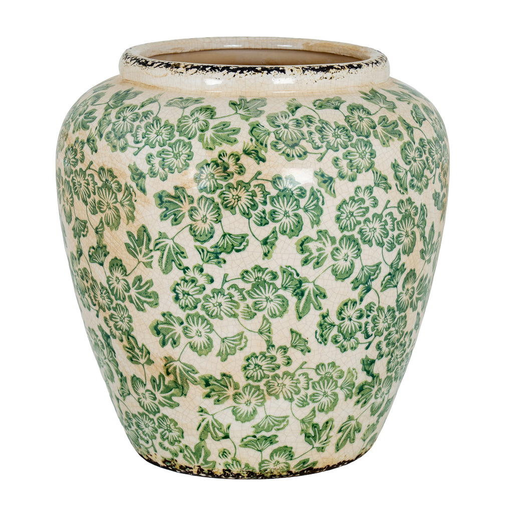 Rounded vase with green flowers and leaves across a cream crackled surface, with dark distressed edging at the rim and base.