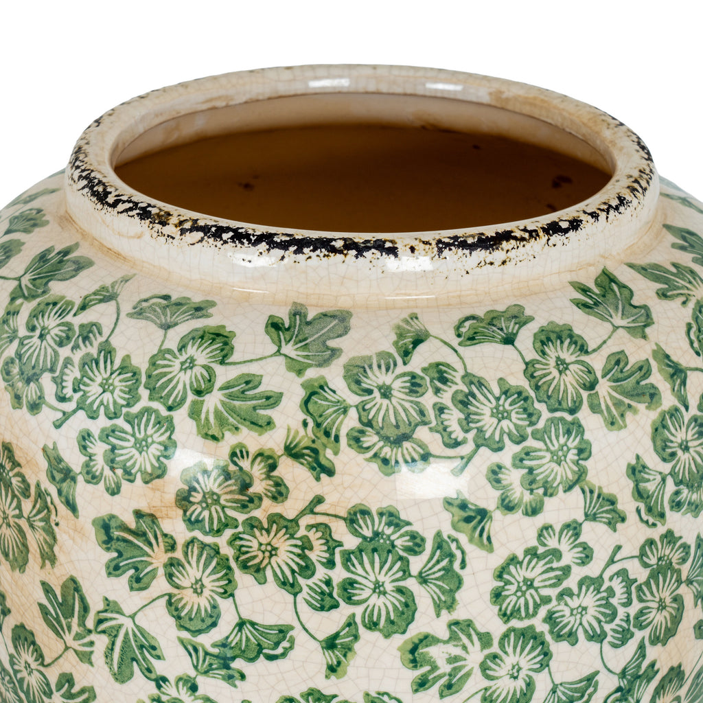 View down into the vase's wide opening, showing its tan interior, raised cream rim with dark markings and green patterned shoulder.