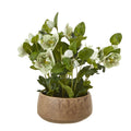 Artificial hellebore arrangement with pale green-white flowers and spreading green foliage in a low taupe pot.