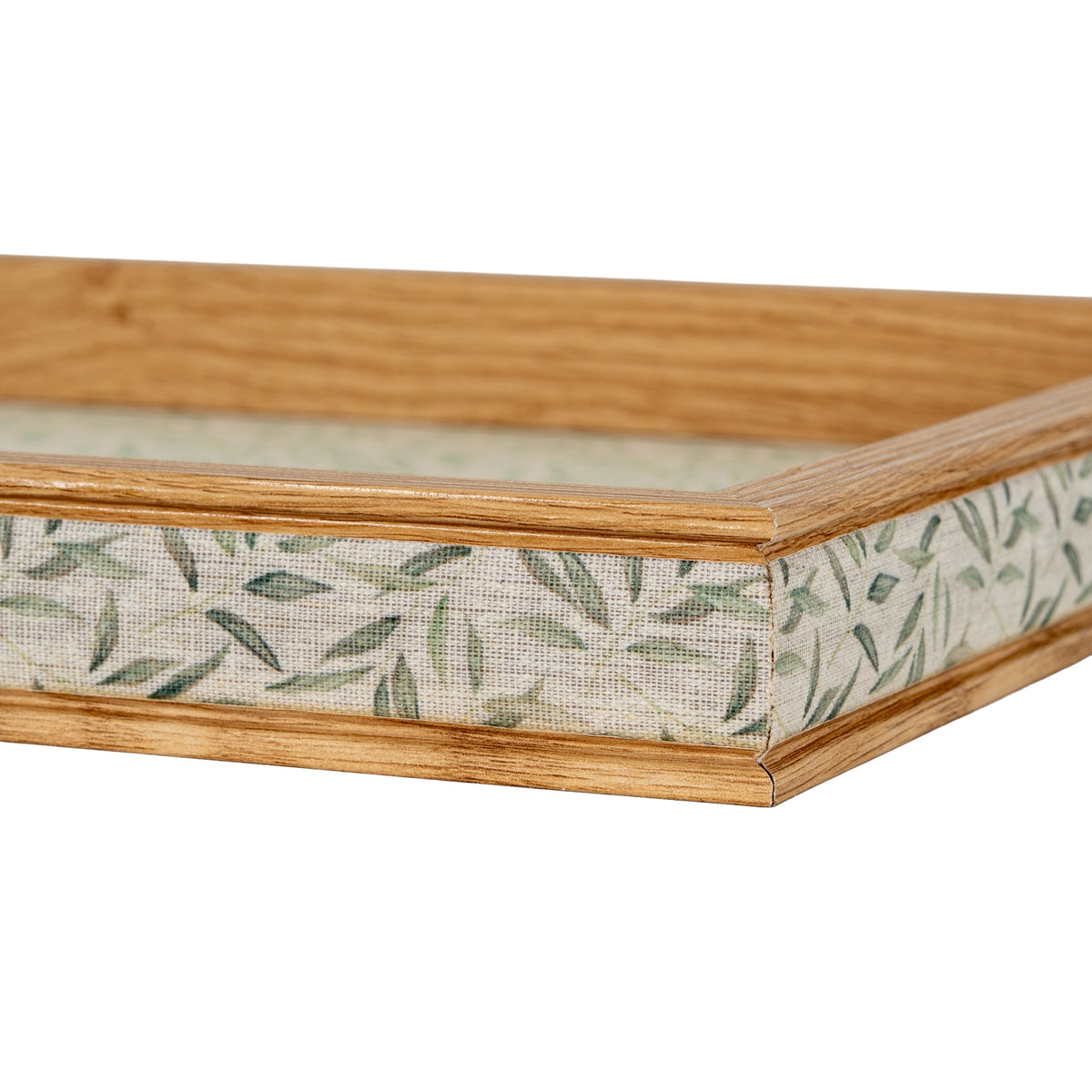 Close-up of a tray corner, showing wood-tone trim above and below the textured green leaf-patterned exterior band.