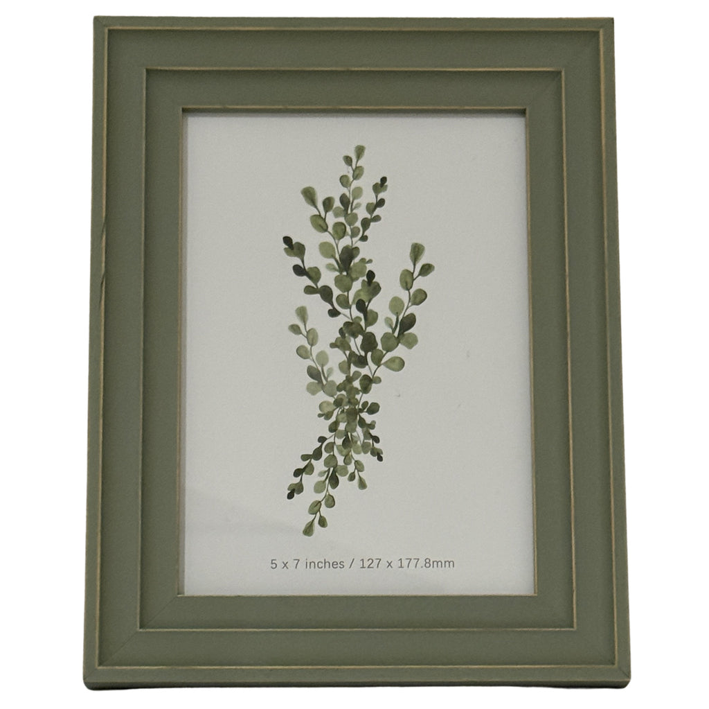 Front view of a green-grey rectangular photo frame with a layered surround, thin gold-tone lines and a botanical insert marked 5 x 7 inches.