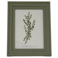 Front view of a green-grey rectangular photo frame with a layered surround, thin gold-tone lines and a botanical insert marked 5 x 7 inches.